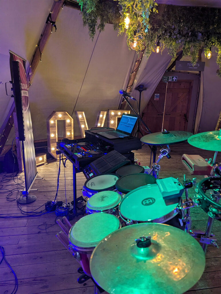 DJ and live percussion setup with LOVE letters at Rylands Farmhouse wedding reception