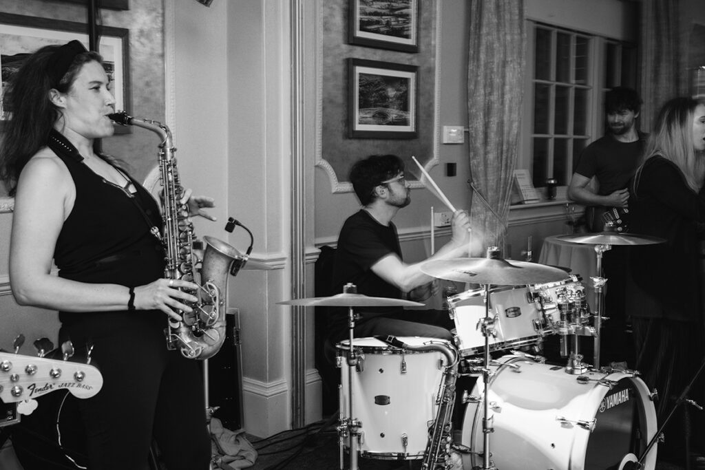 Live saxophone and drums performance by Groove Manuva at Wood Hall wedding reception