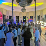 Guests dancing beneath the chandelier at Wynyard Hall during William’s wedding reception with Groove Manuva live band.